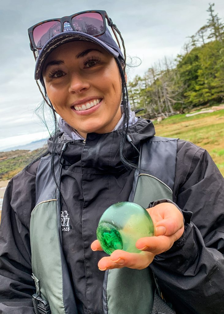 Meaghan holds in her hand the glass fishing ball she discovered on her first day